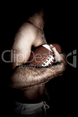 Composite image of side view of shirtless rugby player holding b