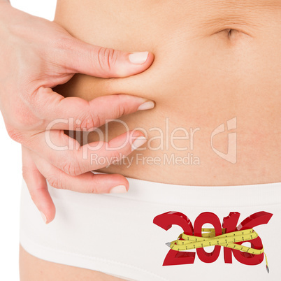 Composite image of fit woman pinching her stomach