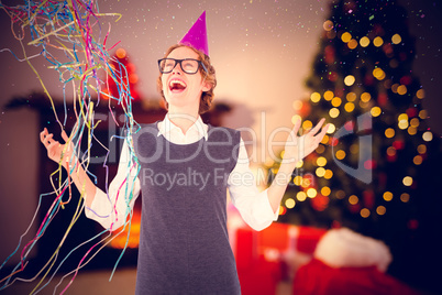 Composite image of happy geeky hipster wearing a party hat