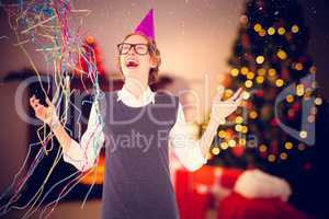 Composite image of happy geeky hipster wearing a party hat