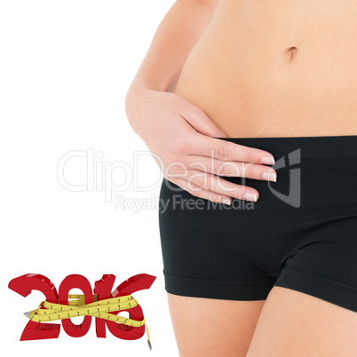 Composite image of closeup mid section of a fit woman in black s