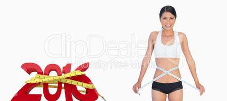 Composite image of cheerful slim woman measuring her waist