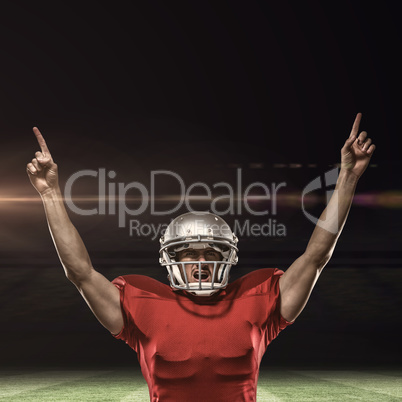 Composite image of american football player with arms raised sta