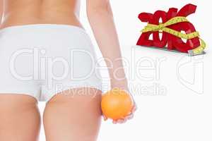 Composite image of midsection of fit woman with orange