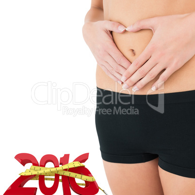 Composite image of closeup mid section of a fit woman in black s