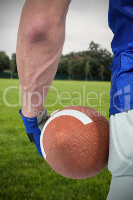 Composite image of midsection of sport person holding ball