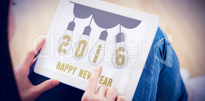 Composite image of teen using a tablet pc sitting on the floor