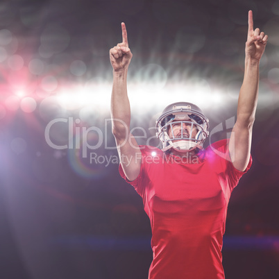 Composite image of american football player looking up with arms raised