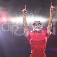 Composite image of american football player looking up with arms raised