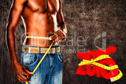 Composite image of mid section of a fit shirtless man measuring