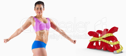 Composite image of fit brunette posing and looking at camera