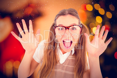 Composite image of female geeky hipster smiling at camera