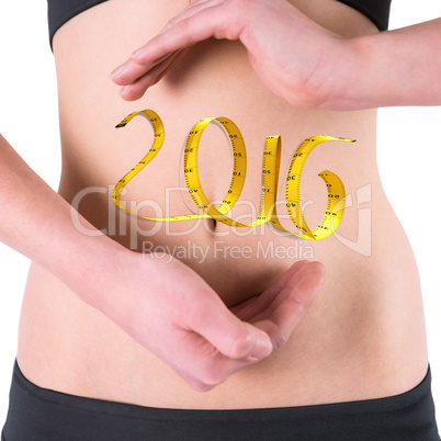 Composite image of woman with hands over belly