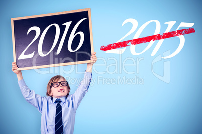 Composite image of cute pupil holding chalkboard