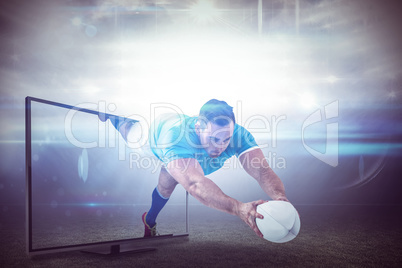 Composite image of rugby player scoring a try