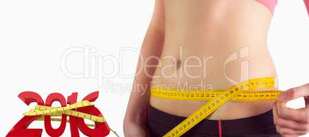 Composite image of woman measuring waist over white background