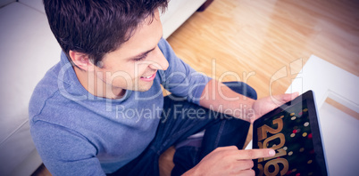 Composite image of overhead view of man using digital tablet in