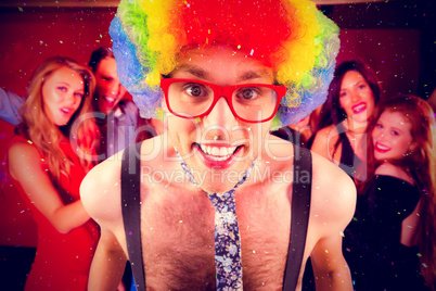 Composite image of geeky hipster in afro rainbow wig