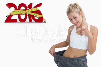 Composite image of young healthy woman wearing old pants after l