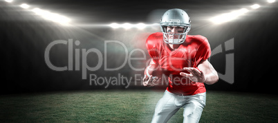 Composite image of portrait of defensive sportsman holding american football