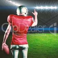 Composite image of rear view of american football player pointing while holding ball