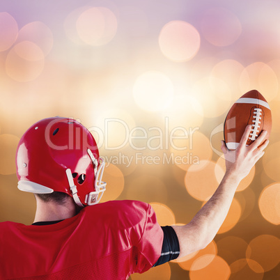 Composite image of rear view of american football player holding