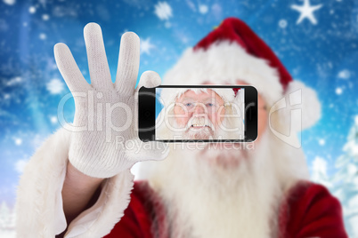 Composite image of hand holding mobile phone