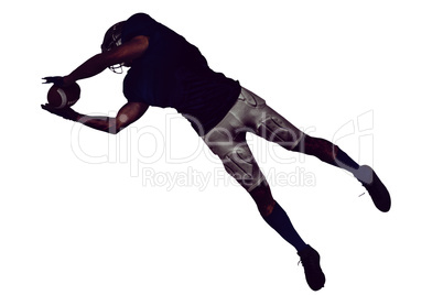 American football player catching ball in mid-air