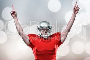 Composite image of american football player with arms raised sta