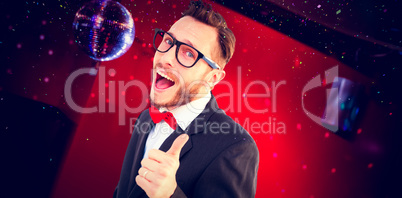 Composite image of geeky hipster pointing at camera