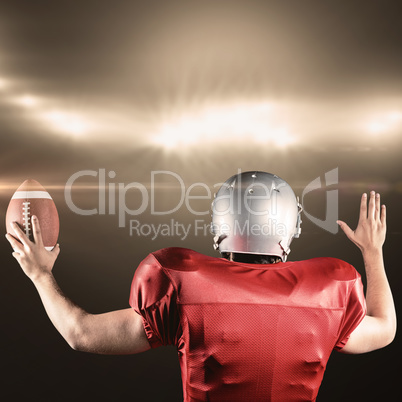 Composite image of rear view of american football player gesturing while holding ball