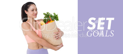 Composite image of slim woman holding bag with healthy food