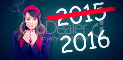 Composite image of festive brunette holding a mug