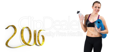 Composite image of fit brunette holding mat and sports bottle