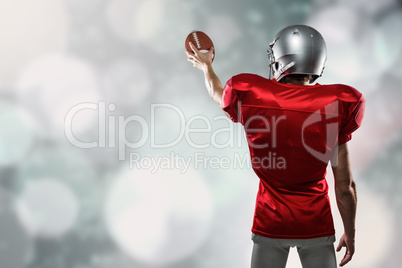 Composite image of rear view of sport player in red jersey holdi