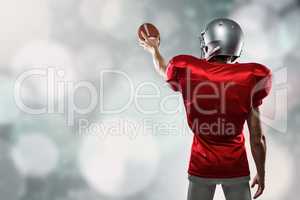 Composite image of rear view of sport player in red jersey holdi