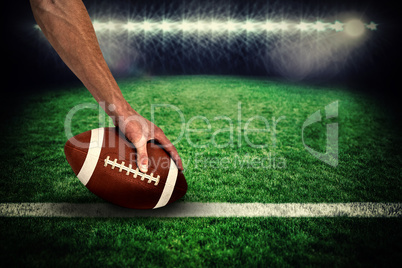 Composite image of close-up of american football player placing