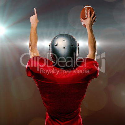 Composite image of rear view of american football player with arms raised