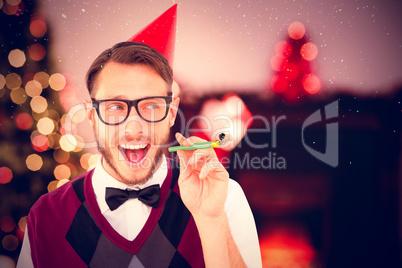 Composite image of geeky hipster in party hat with horn