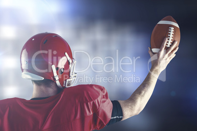 Composite image of rear view of american football player holding