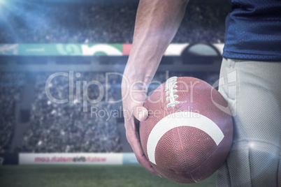Composite image of midsection of sports player holding ball Composite image of midsection of sports player holding ball