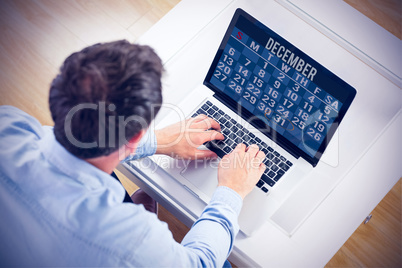 Composite image of man using laptop