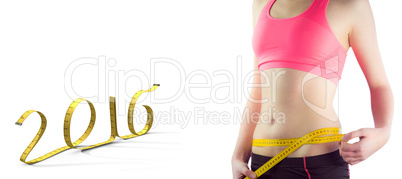 Composite image of sporty woman measuring waist over white backg