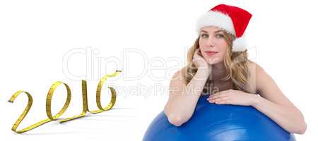 Composite image of festive fit blonde leaning on exercise ball