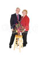 Dressed up senior couple with flowers.