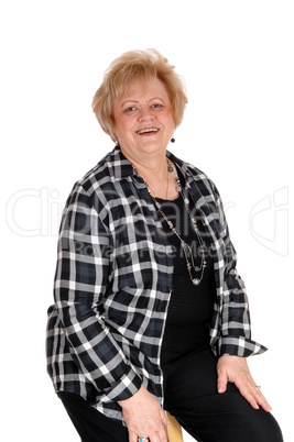 Senior woman sitting on chair.