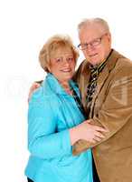 Senior couple standing and hugging.