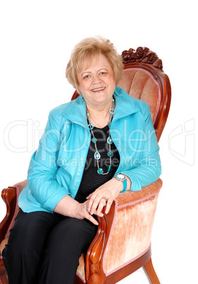 Senior woman sitting in armchair.