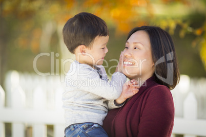 Chinese Mom Having Fun and Holding Her Mixed Race Boy