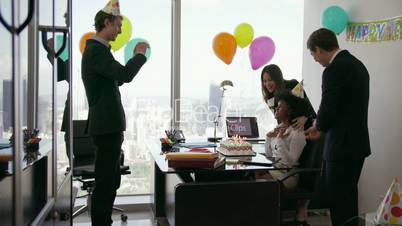 2 Business People Celebrating Colleague Birthday Party In Office